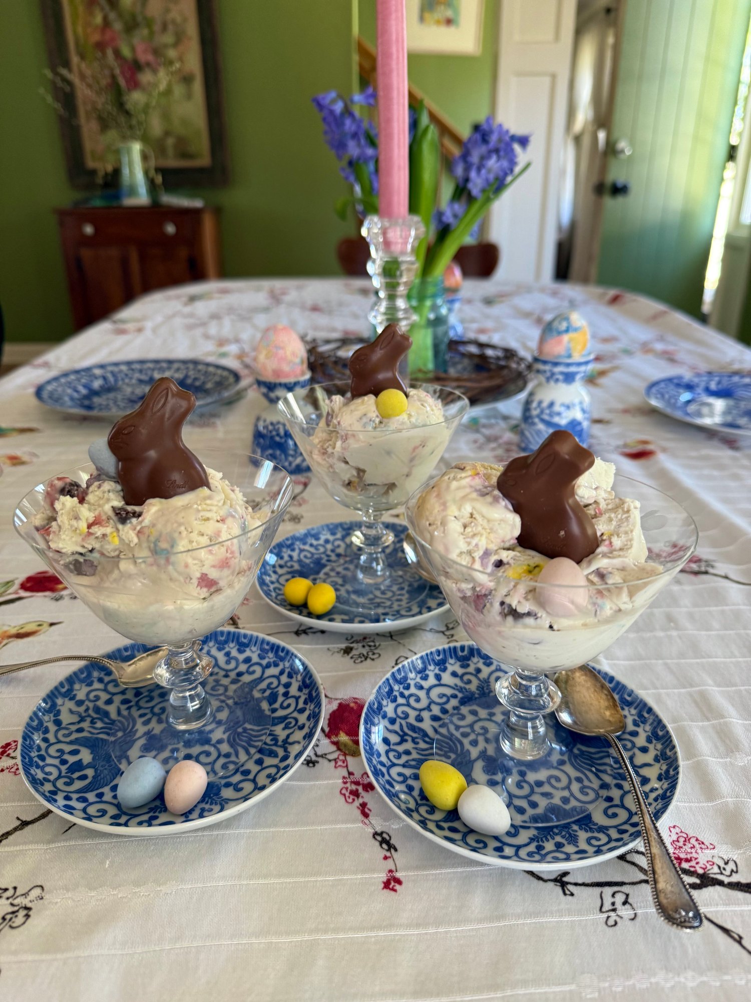 Ice cream bowls with chocolate bunnies on a decorated table